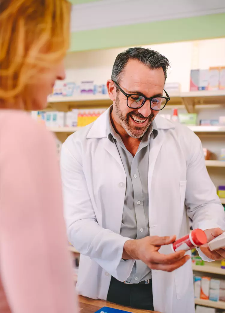 male pharmacist helping woman